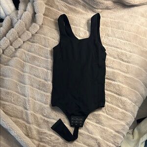 Sleek Black Ribbed Women's Bodysuit with Hook Closure